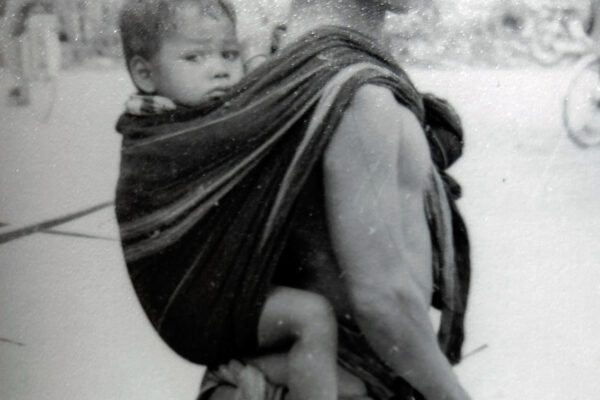 Man with baby on back Vietnam war