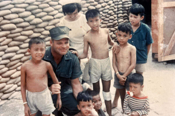 US General Olsen with a nurse and children during Vietnam war