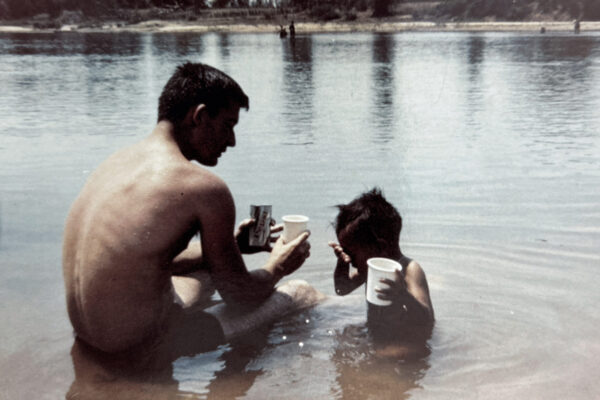 American GI and child swimming during Vietnam War