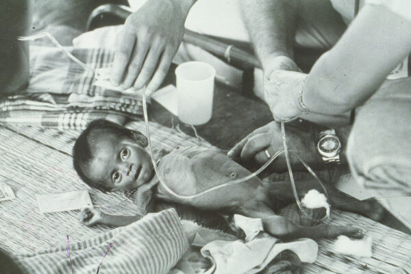 Anne Watts nursing very sick child in Vietnam